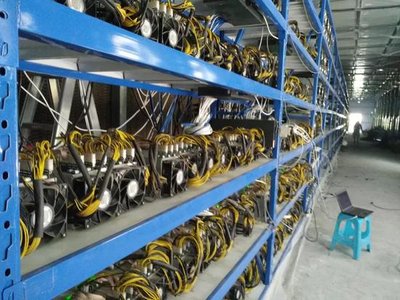 A wide angle view of a well-maintained, expansive mining farm with rows of mining rigs.